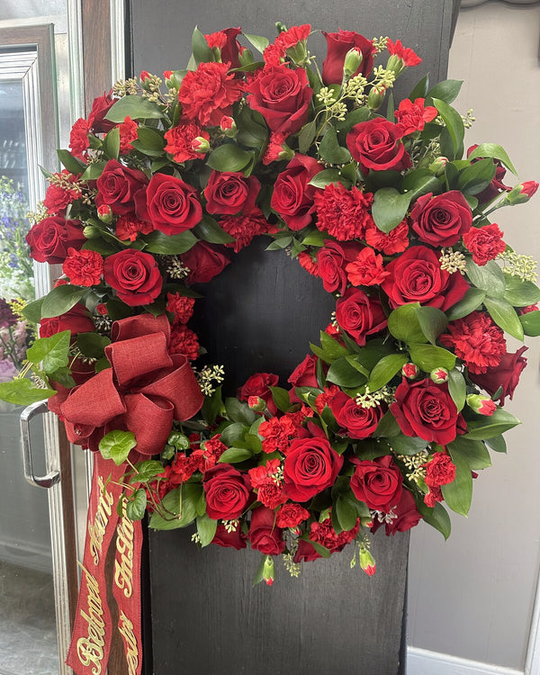 Red Rose Wreath — a wreath of rich red roses, a bold and heartfelt tribute