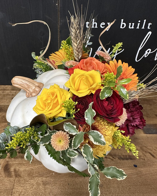 White Pumpkin — fall arrangement of roses, gerbera daisies, ranunculus and wheat in a white pumpkin container