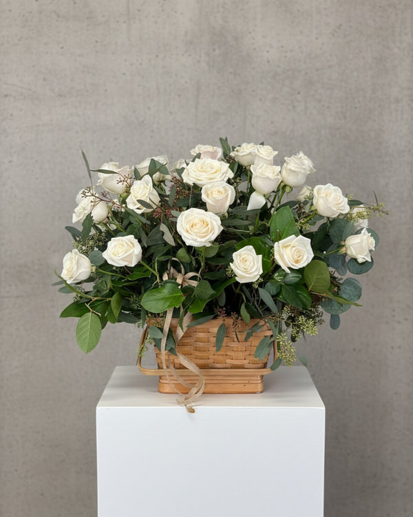 White Memorial Basket — a basket arrangement of white roses, lilies, and greenery, simple and comforting