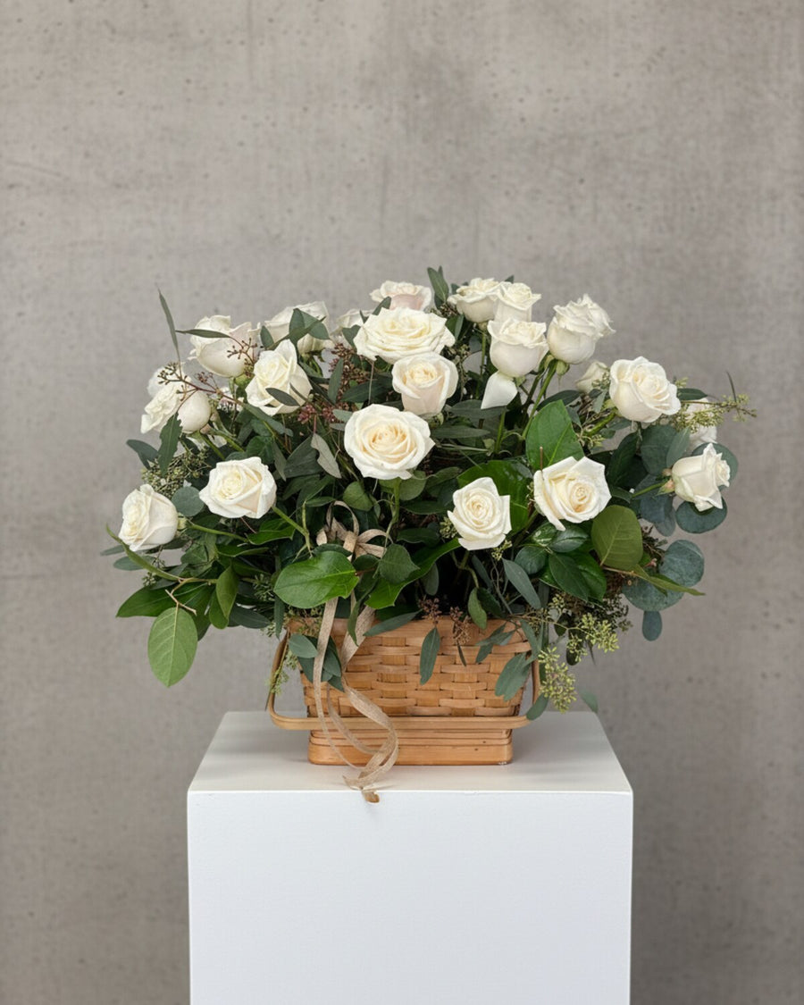 White Memorial Basket — a basket arrangement of white roses, lilies, and greenery, simple and comforting