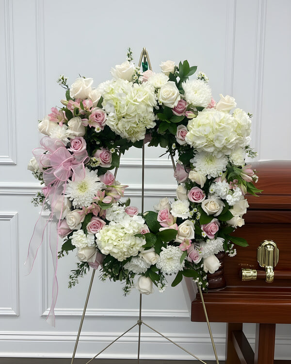 Blush Wreath — a wreath of soft blush and white blooms, gentle and comforting