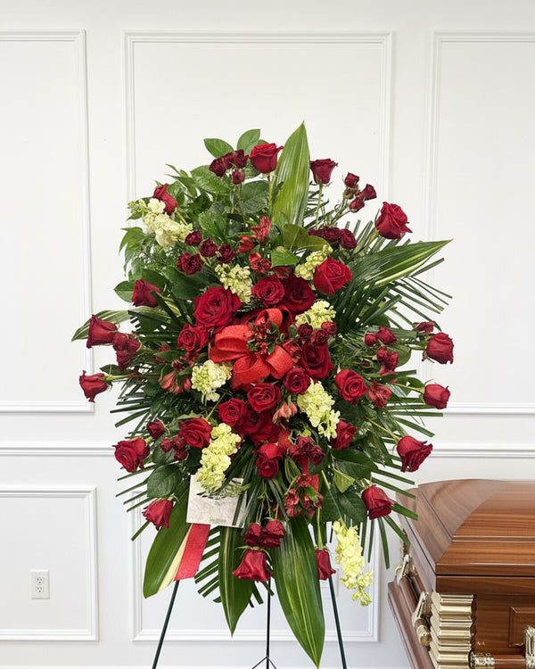 Red Standing Spray — a standing spray of rich red roses and seasonal greenery