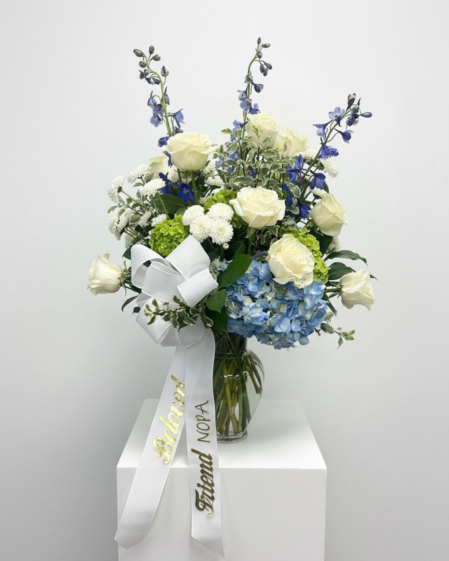 Blue Hydrangea Urn — blue hydrangea and tall blue delphinium with white roses and white hydrangea, arranged in a vase with fresh greens.