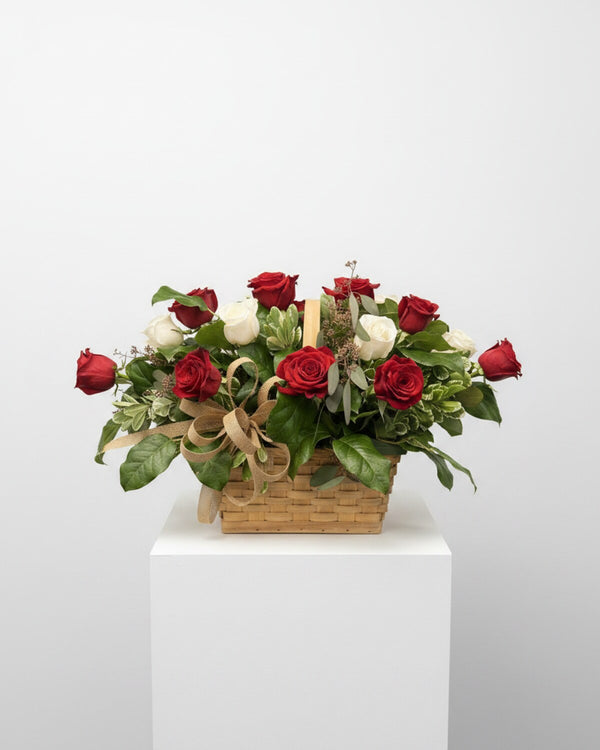 Red Basket — a stunning arrangement of vibrant red roses paired with crisp white blooms, accented with seeded eucalyptus, variegated pittosporum, and fresh lemon leaf